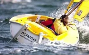 A yellow Hansa sailing through spray