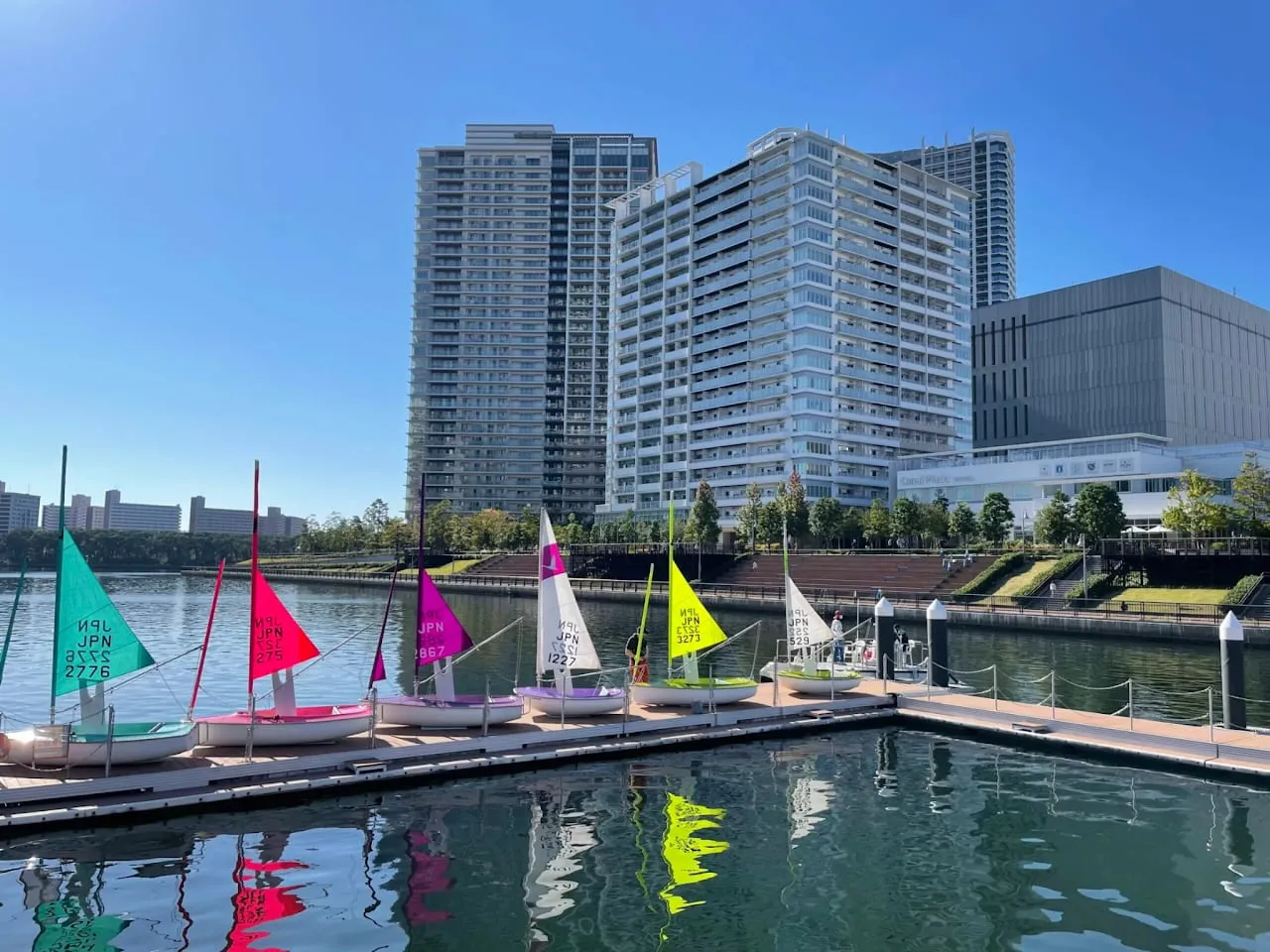 Hansa boats with colorful sails lined up at the pier